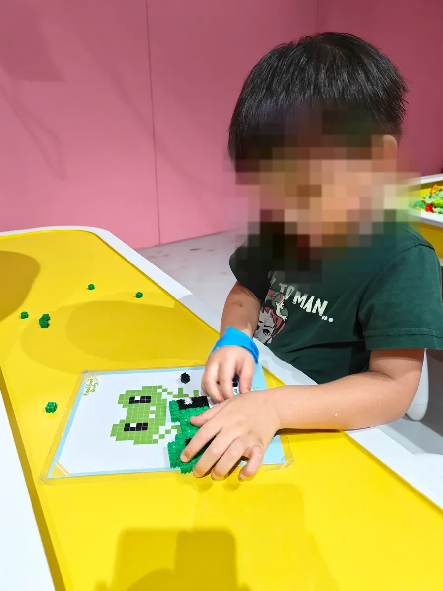 A child making Pix Brix pixel art at the craft table in Wan To Play Sky Castle, Pasir Ris.